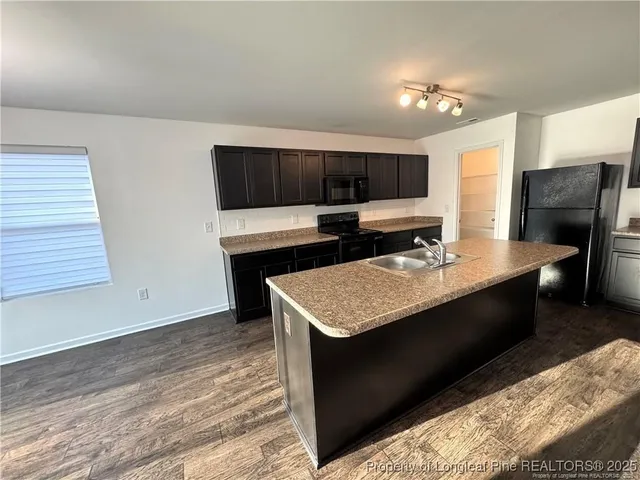 a bathroom with a granite countertop sink a mirror and vanity
