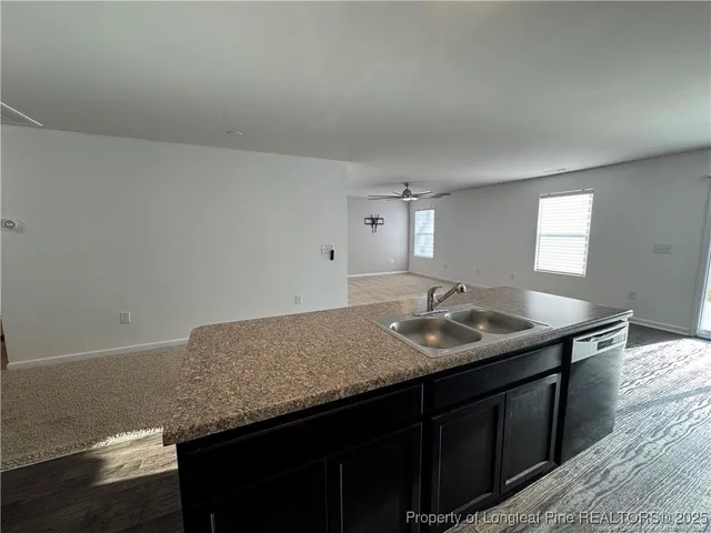 a kitchen with a sink and a refrigerator