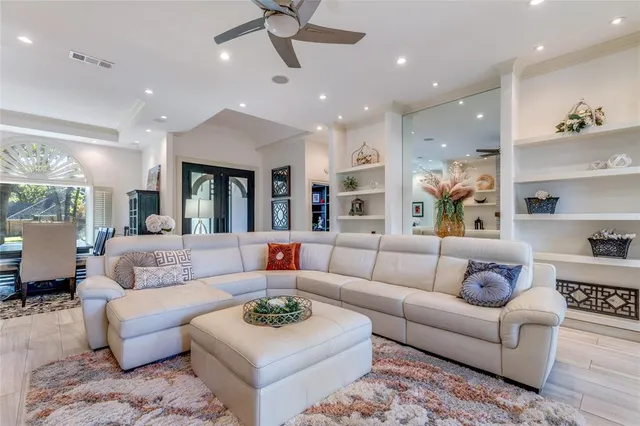 a living room with furniture and a large mirror