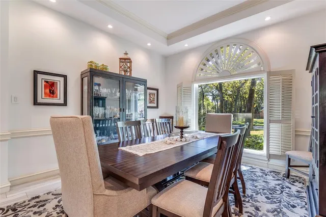 a dining room with furniture a rug and a chandelier