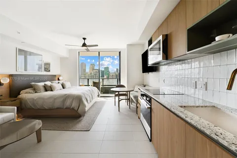 a living room with granite countertop furniture and a flat screen tv