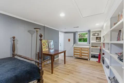 a bedroom with furniture and a wooden floor
