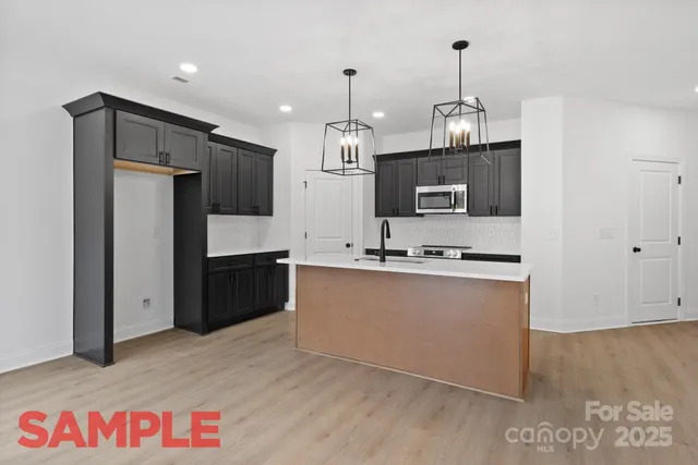 a view of a kitchen with a sink stainless steel appliances and cabinets