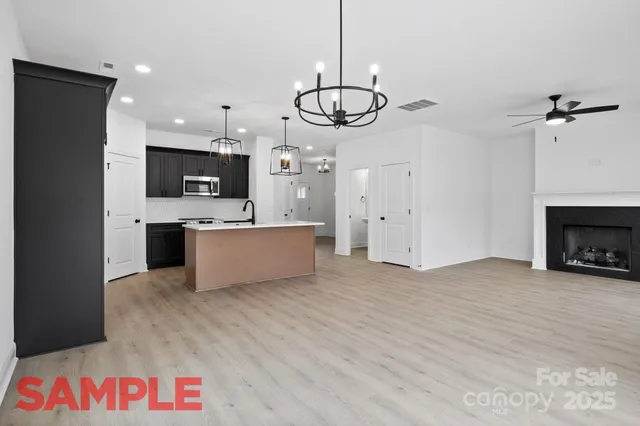 a kitchen with kitchen island granite countertop a sink and stainless steel appliances