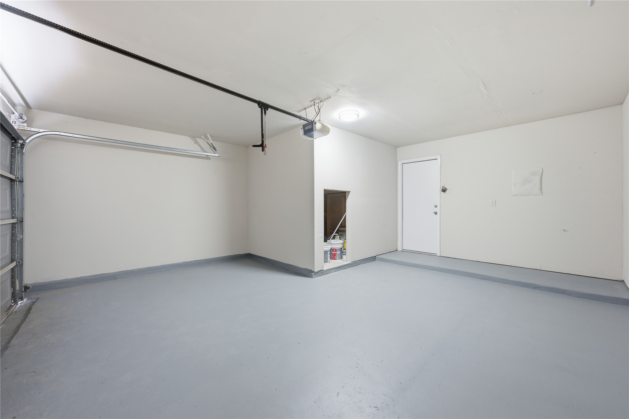 6917 Panda Royle Drive Del Valle, TX 78617 - Photo 11 of 23 An immaculate garage provides ample space and a clean, durable floor for vehicles and storage.