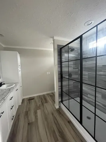 a view of empty room with wooden floor