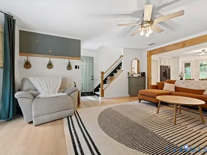 a living room with furniture and a chandelier