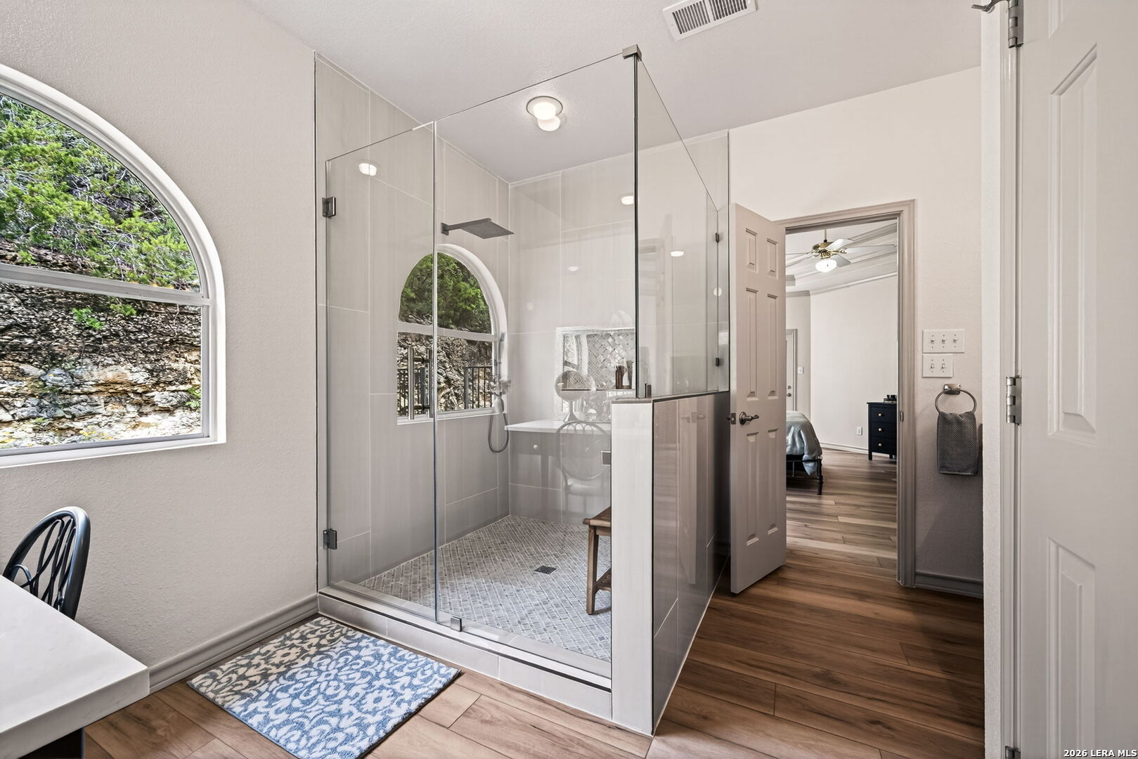 17431 Helotes Spring Road Helotes, TX 78023 - Photo 26 of 50 a bathroom with a glass shower door and a window