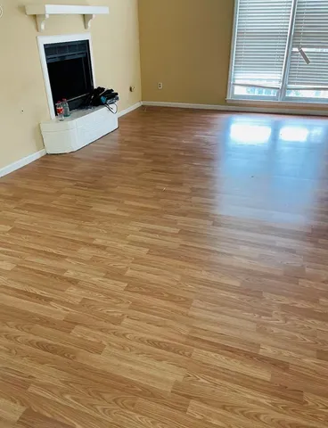 a view of a room with wooden floor and a flat screen tv
