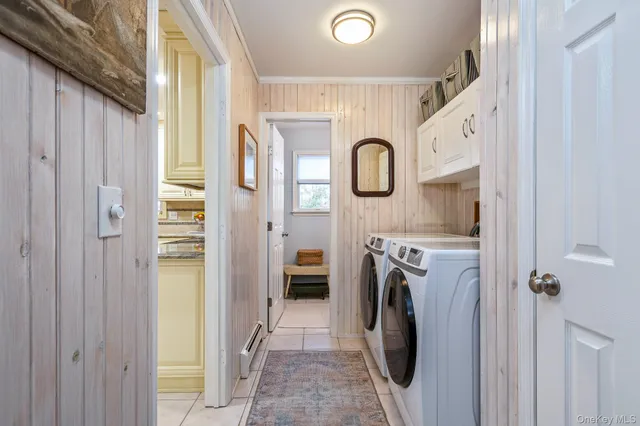 a view of a storage and utility room with washer and dryer