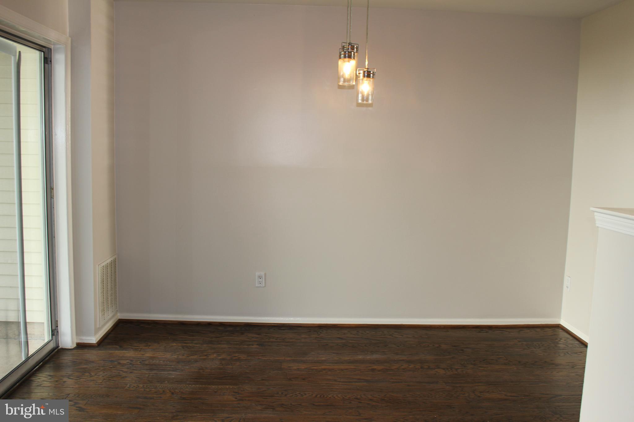 175 Leedom Way Newtown, PA 18940 - Photo 15 of 36 an empty room with wooden floor and chandelier