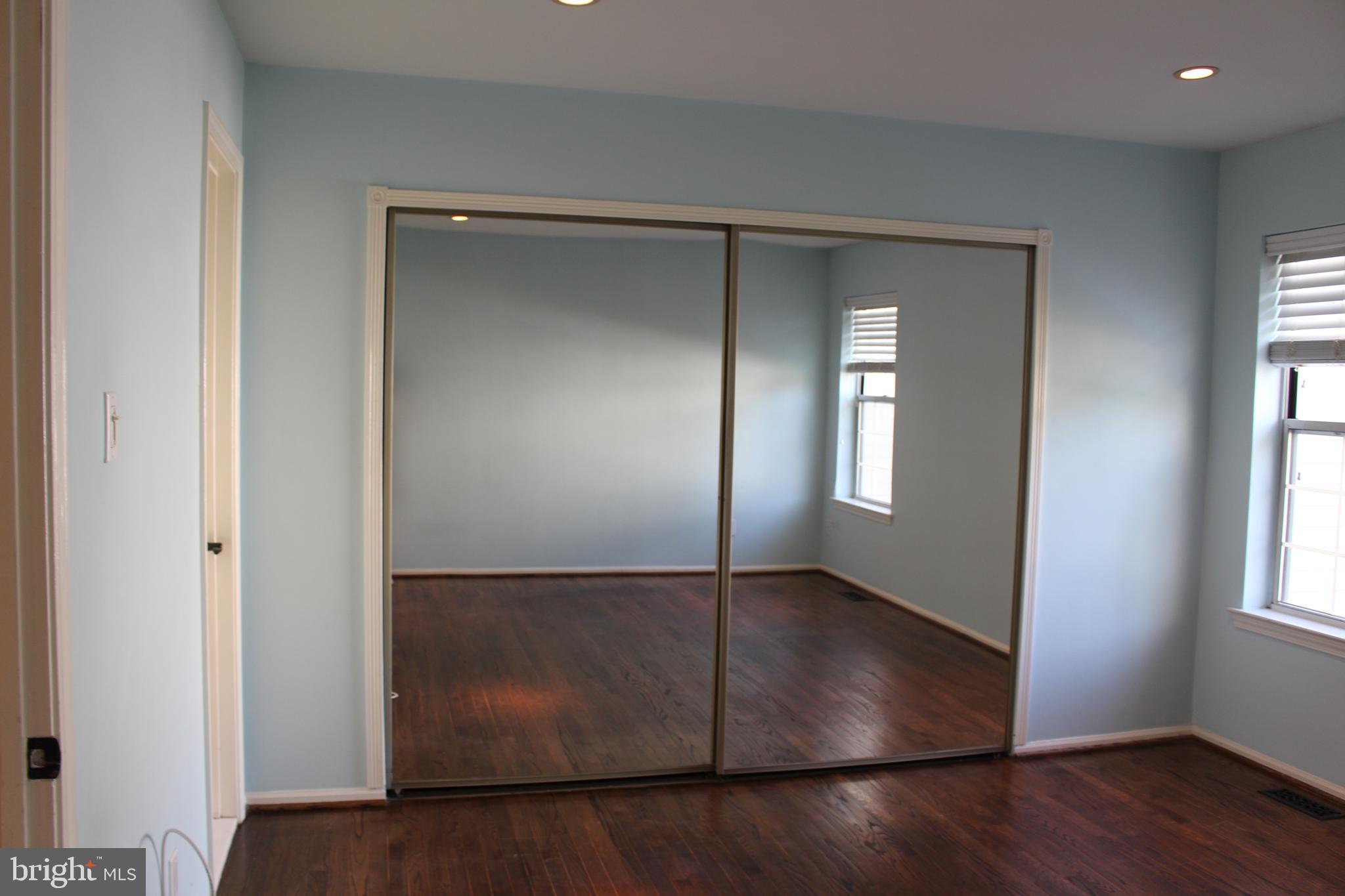175 Leedom Way Newtown, PA 18940 - Photo 20 of 36 an empty room with wooden floor and windows