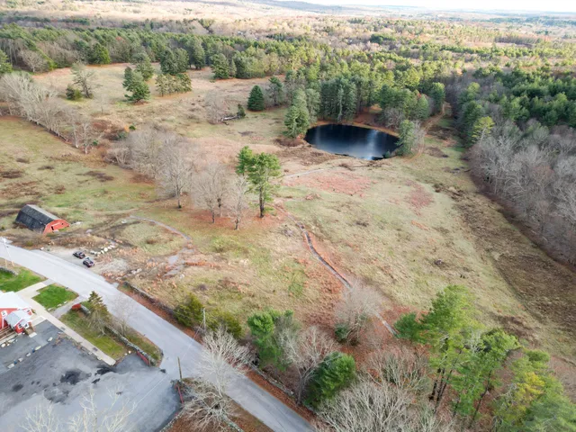 a view of a dry yard with wooden fence