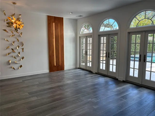 a view of an entryway with wooden floor