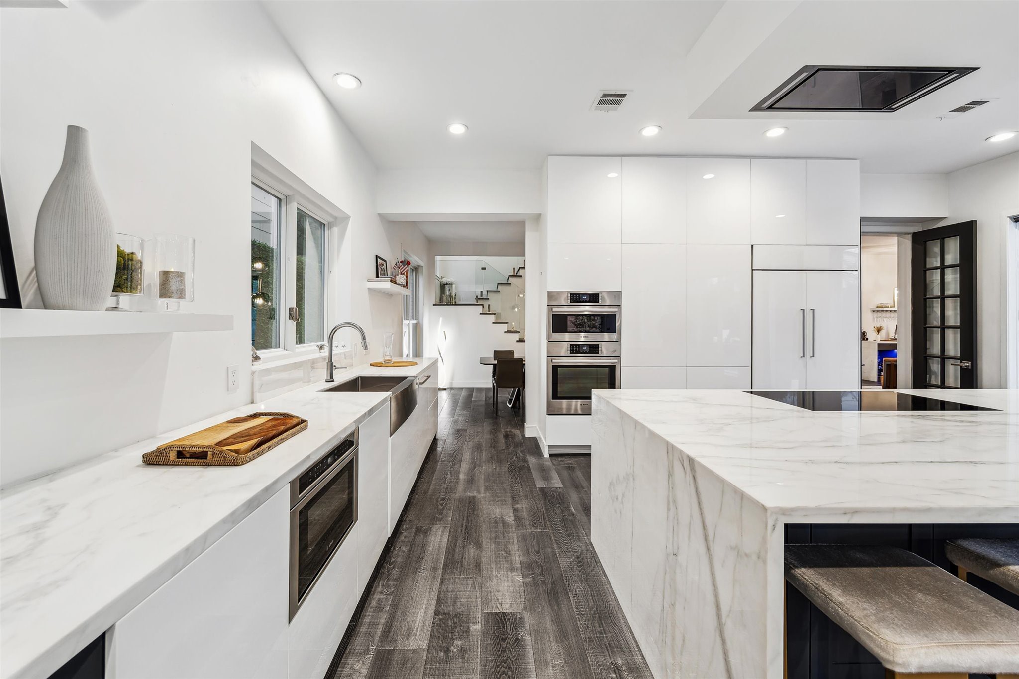 2114 Wroxton Road Houston, TX 77005 - Photo 19 of 48 a large kitchen with kitchen island a sink stove and wooden floor