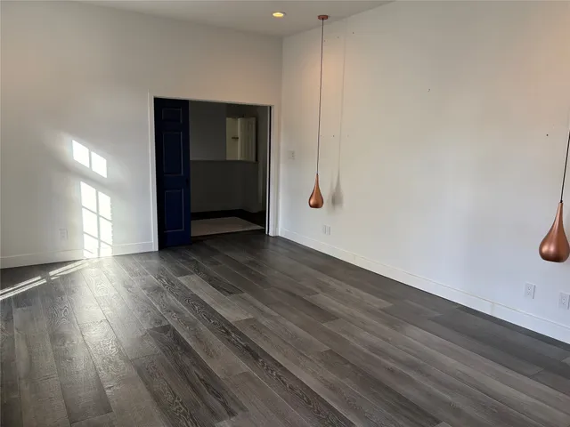 a view of an empty room and wooden floor