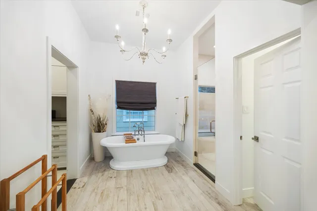 a spacious bathroom with a double vanity sink a mirror a bathtub and shower