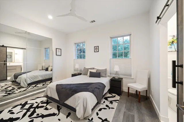 a bedroom with a bed and wooden floor