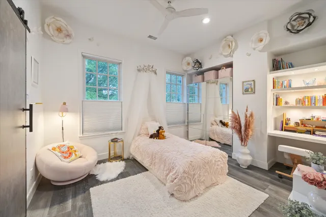 a bedroom with furniture and a large window