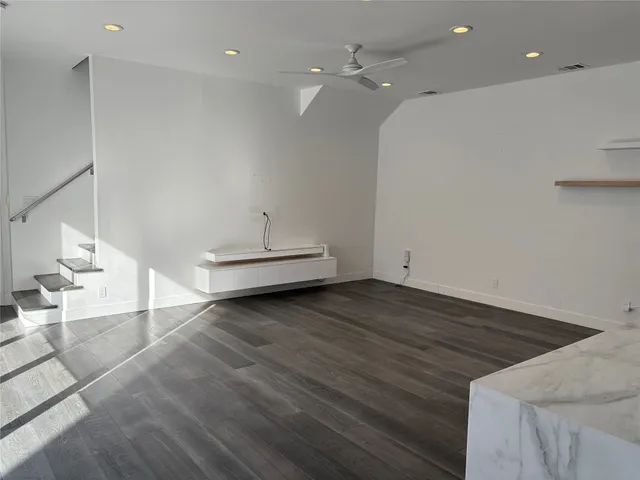 a view of a room with wooden floor