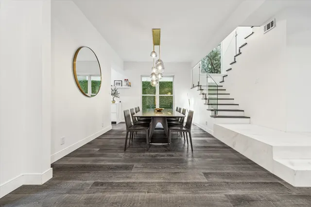a dining room with furniture entryway and wooden floor