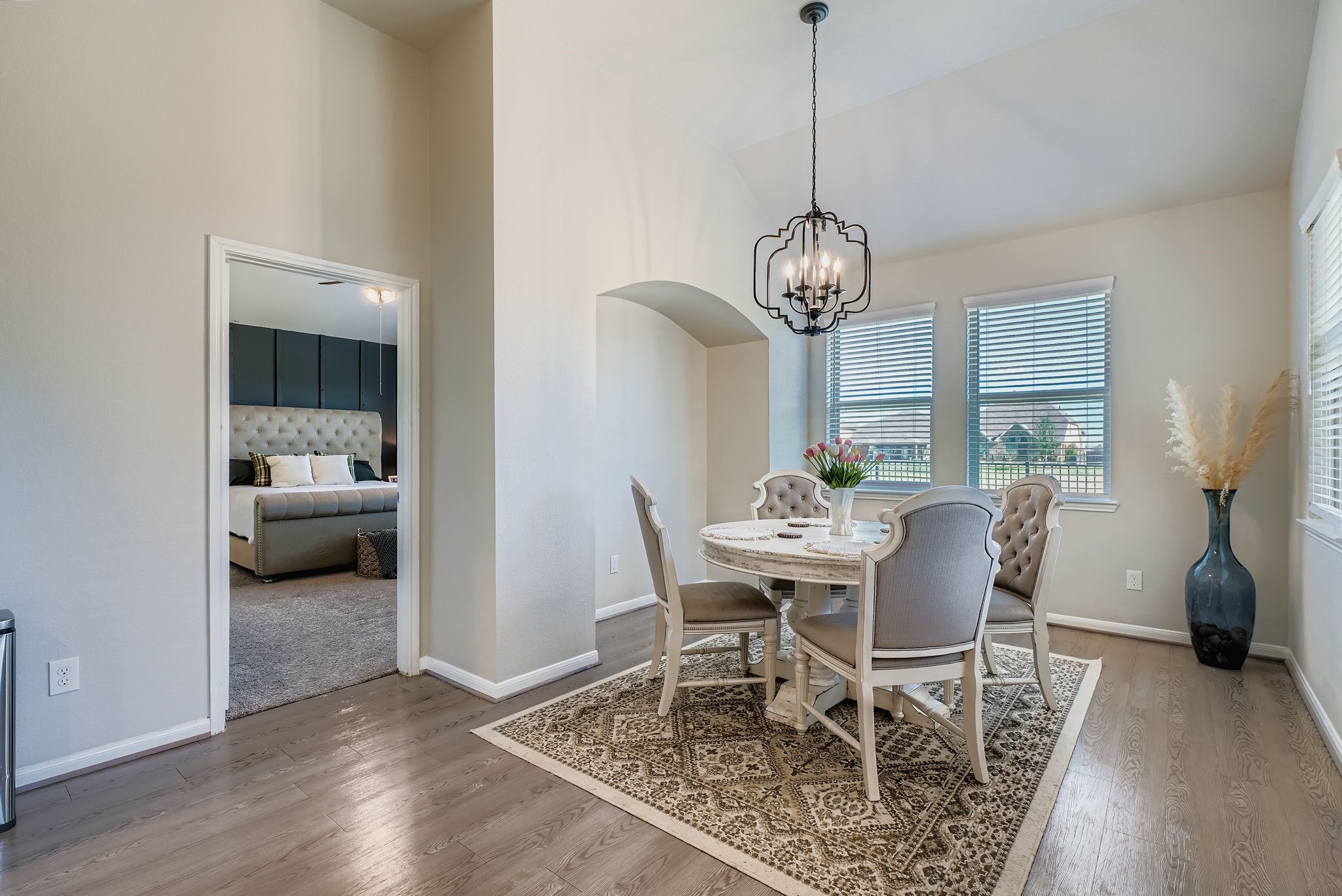 2614 Wembley Way Rosenberg, TX 77471 - Photo 12 of 24 a dining room with wooden floor a chandelier a wooden table and chairs