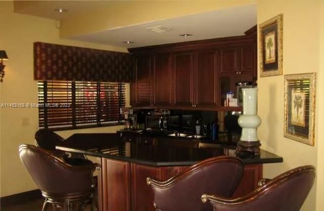 4055 West McNab Road, Unit H303 Pompano Beach, FL 33069 - Photo 12 of 29 a bathroom with a sink and a mirror