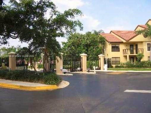 4055 West McNab Road, Unit H303 Pompano Beach, FL 33069 - Photo 16 of 29 a front view of a house with yard and green space