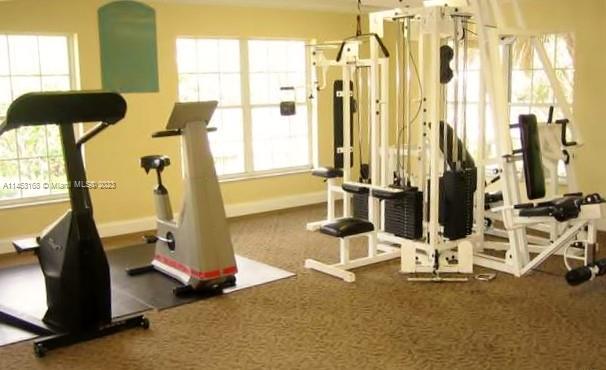 4055 West McNab Road, Unit H303 Pompano Beach, FL 33069 - Photo 20 of 29 a room with gym equipment and windows