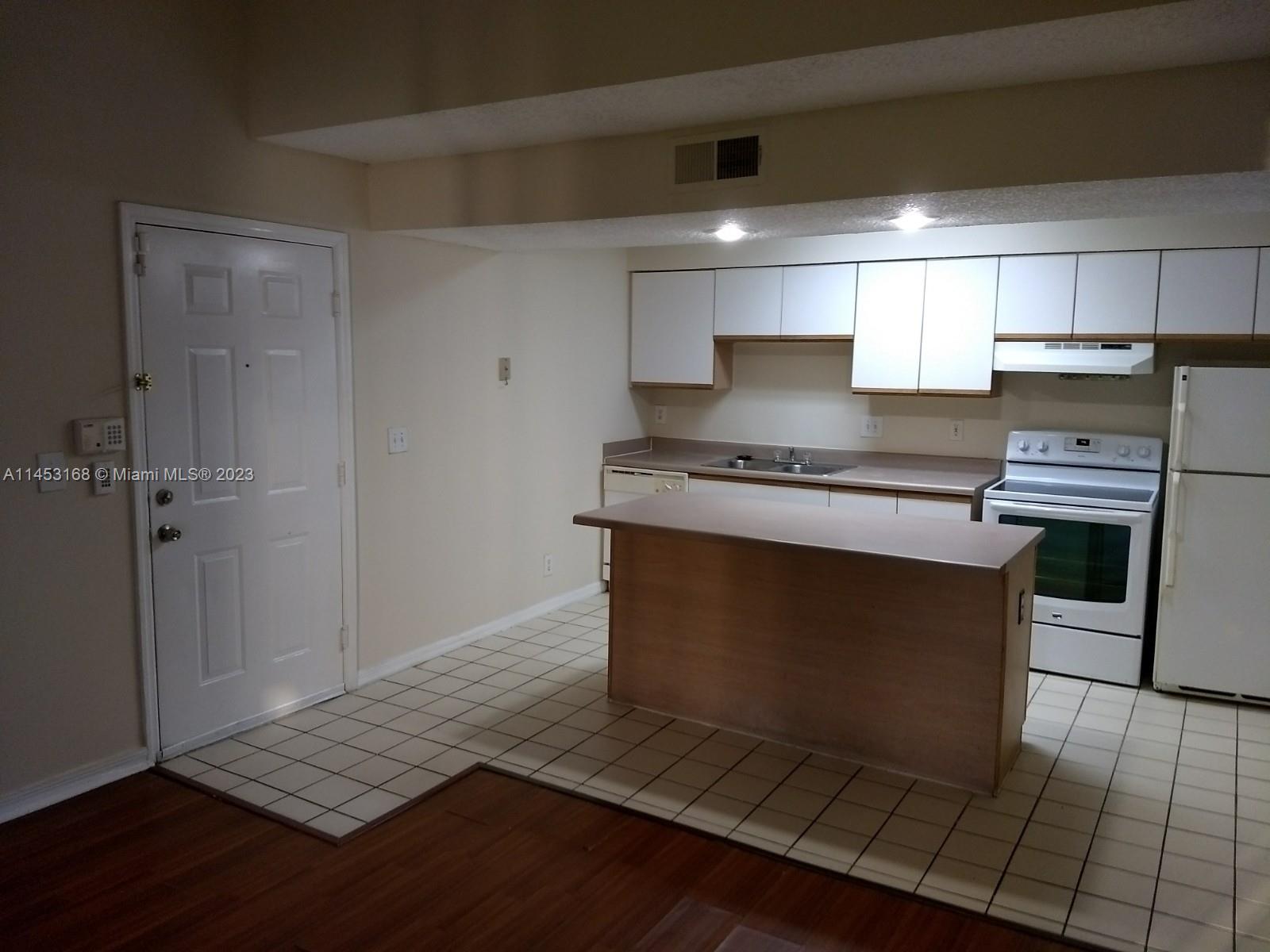 4055 West McNab Road, Unit H303 Pompano Beach, FL 33069 - Photo 2 of 29 a kitchen with granite countertop a stove and a refrigerator