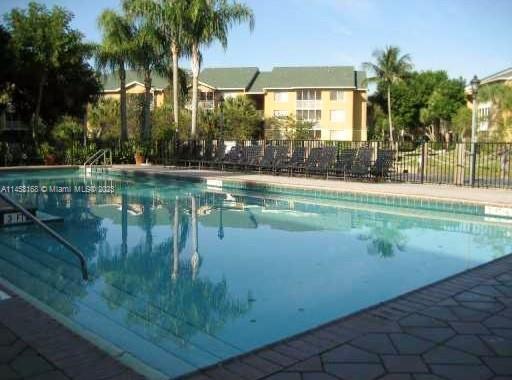 4055 West McNab Road, Unit H303 Pompano Beach, FL 33069 - Photo 24 of 29 a view of swimming pool next to a lake view