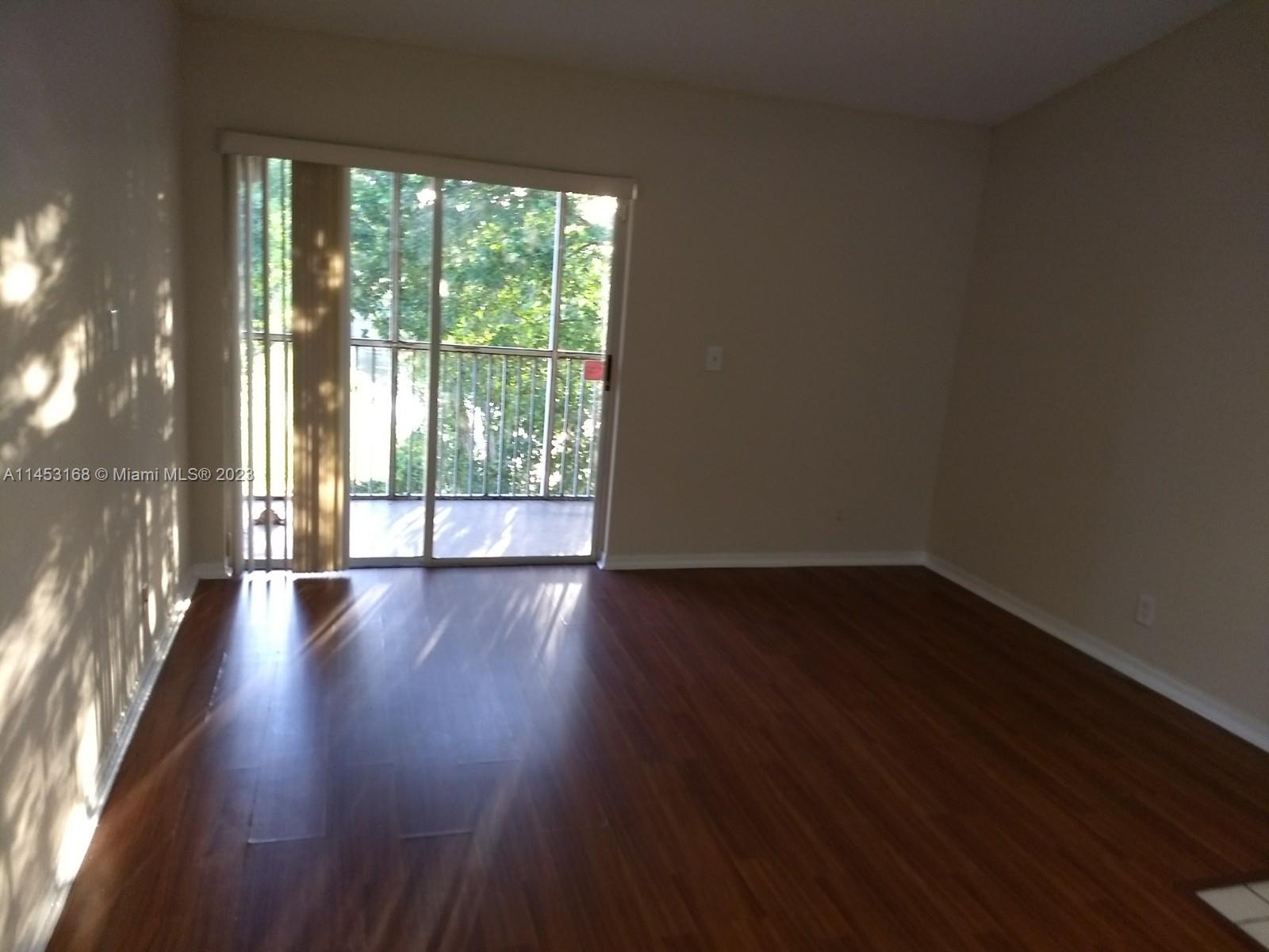 4055 West McNab Road, Unit H303 Pompano Beach, FL 33069 - Photo 3 of 29 a view of a big room with wooden floor and windows