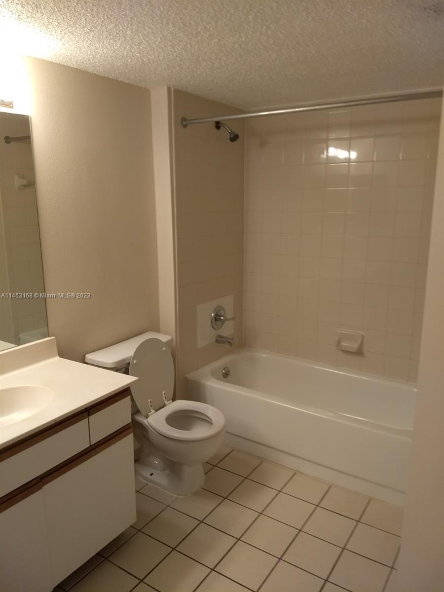 4055 West McNab Road, Unit H303 Pompano Beach, FL 33069 - Photo 8 of 29 a bathroom with a sink a toilet and shower