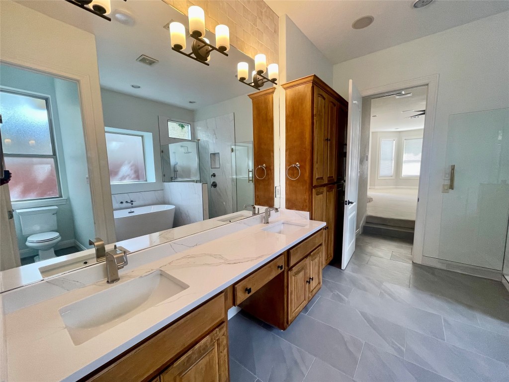 1014 Challenger Lakeway, TX 78734 - Photo 11 of 16 a bathroom with a sink a vanity a mirror and shower