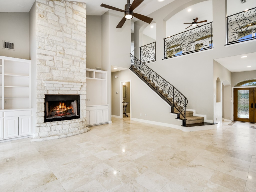 1014 Challenger Lakeway, TX 78734 - Photo 6 of 16 a view of an empty room with stairs and a fireplace