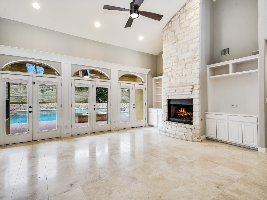1014 Challenger Lakeway, TX 78734 - Photo 7 of 16 a view of an empty room with a fireplace and a window