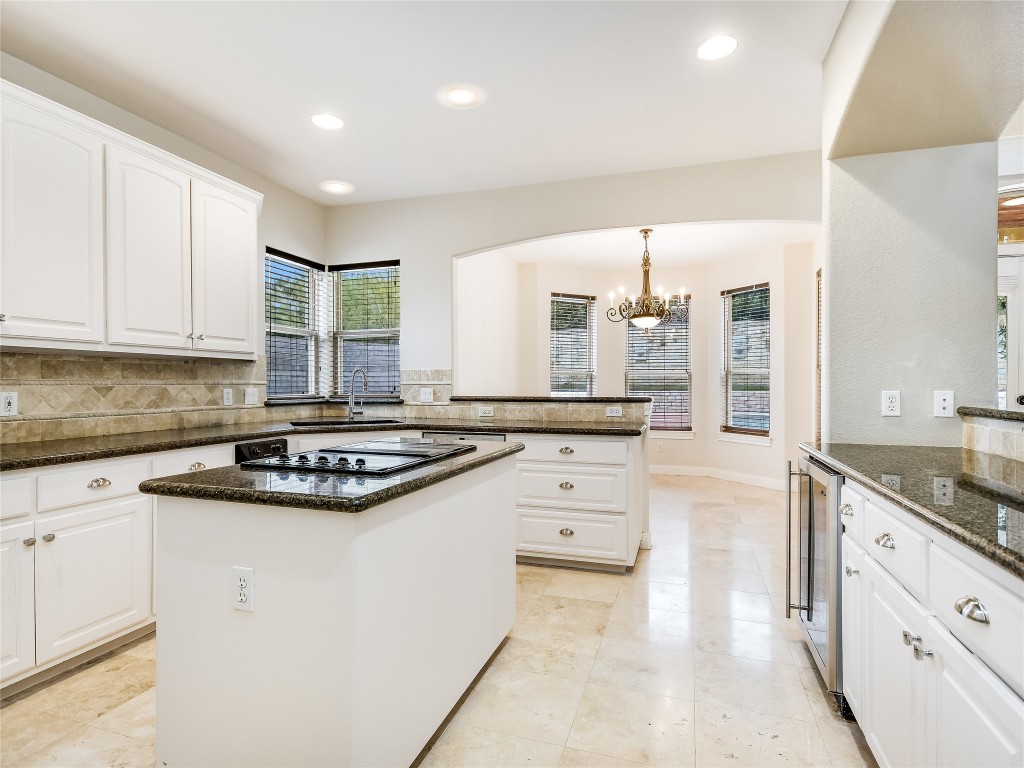 1014 Challenger Lakeway, TX 78734 - Photo 8 of 16 a kitchen with granite countertop a sink stove and cabinets