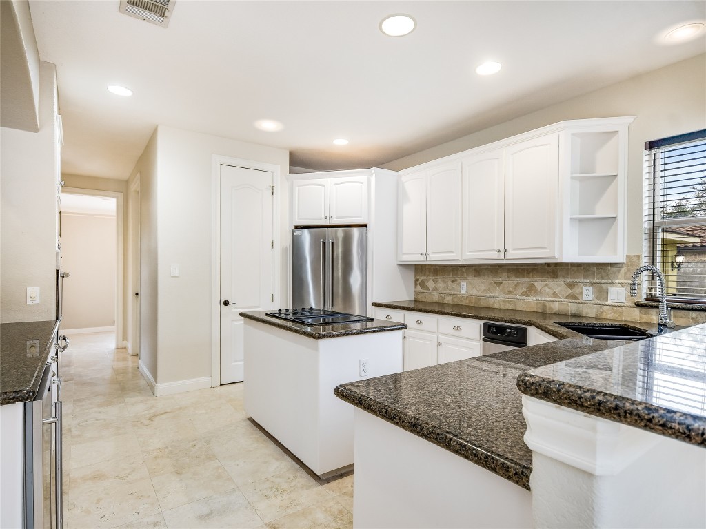 1014 Challenger Lakeway, TX 78734 - Photo 9 of 16 a kitchen with a stove a sink and a refrigerator