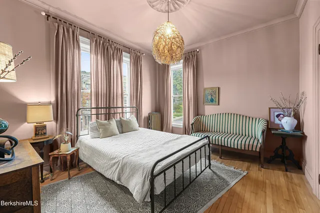 a bedroom with a bed and a chandelier