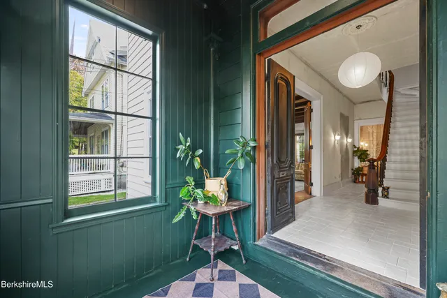 a dining room with furniture and a window