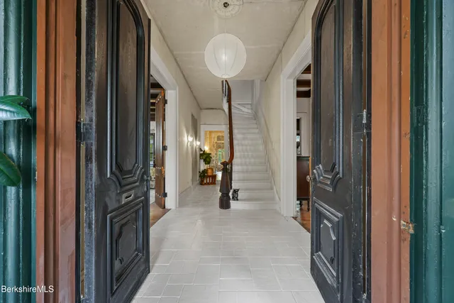a view of a hallway with wooden shelves