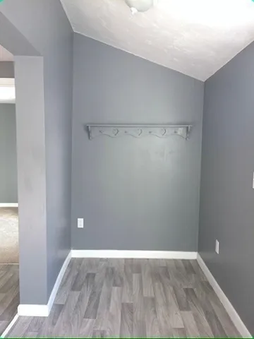 a view of a room with wooden floor