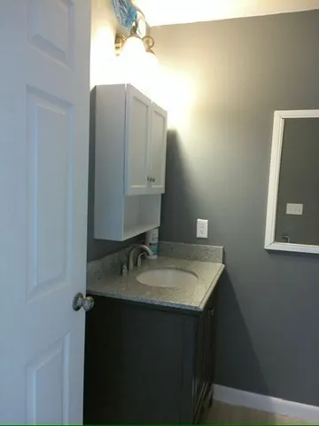 a bathroom with a sink and mirror