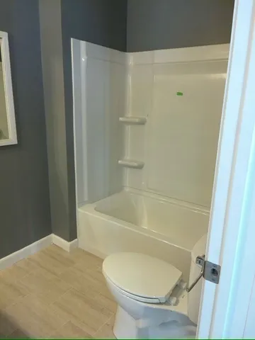 a bathroom with a toilet and a bathtub