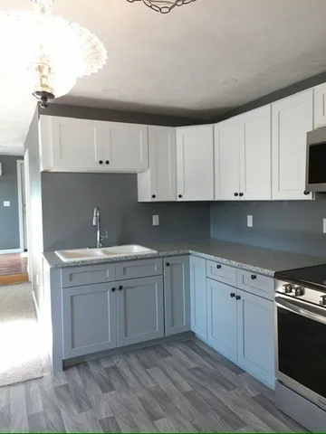 a kitchen with a sink cabinets and appliances