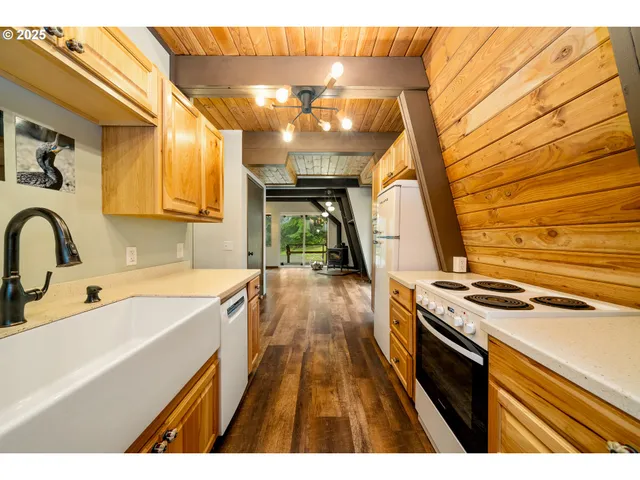 a kitchen with a sink a stove and cabinets