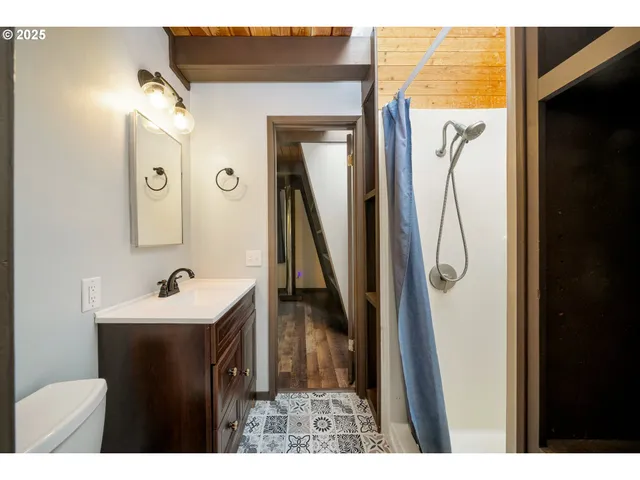 a bathroom with a sink vanity and a mirror