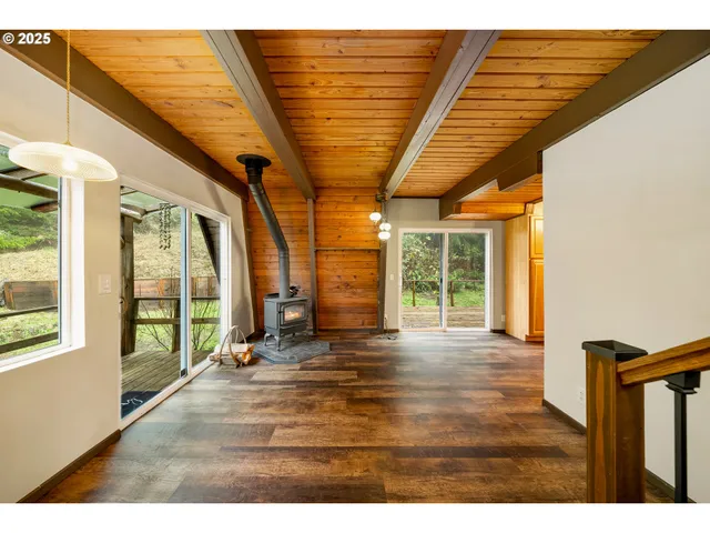 a view of outdoor space with wooden floor and windows