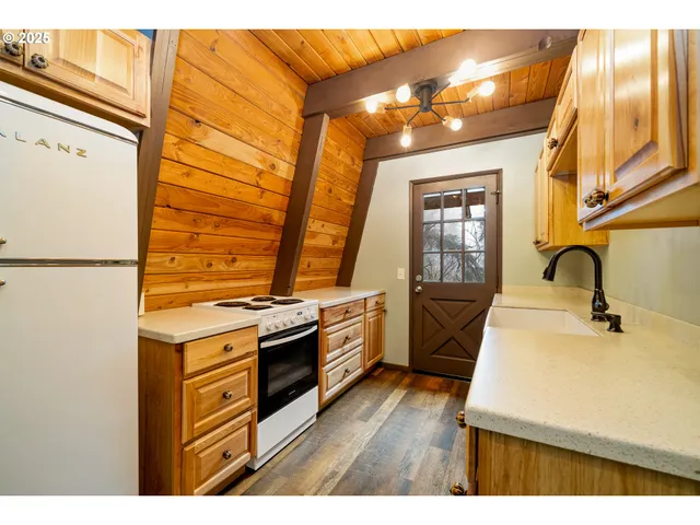 a kitchen with stainless steel appliances a stove a sink and a refrigerator