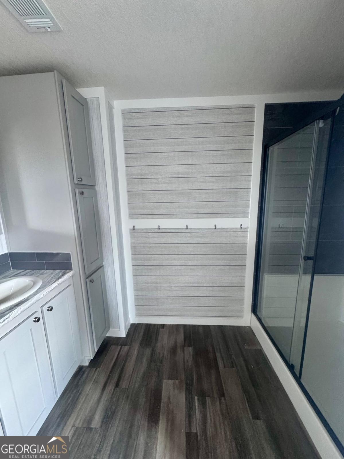 59 Long Leaf Road Hazlehurst, GA 31539 - Photo 13 of 19 a view of walk in closet with wooden floor and staircase